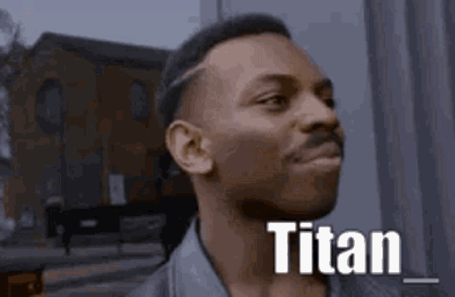 a man with the word titan on his face .