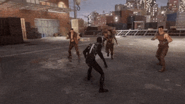 a group of men are playing a video game and one of them is wearing a black spiderman suit
