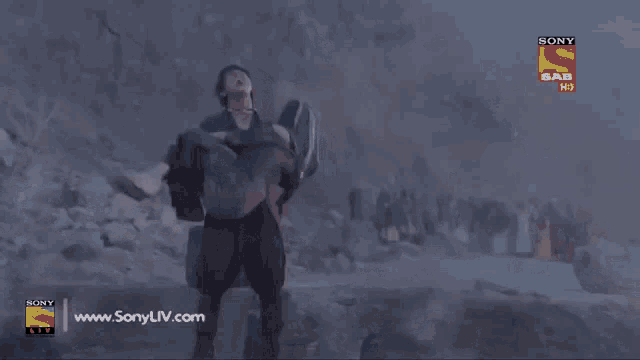 a man is carrying a woman in his arms with a sony logo in the corner