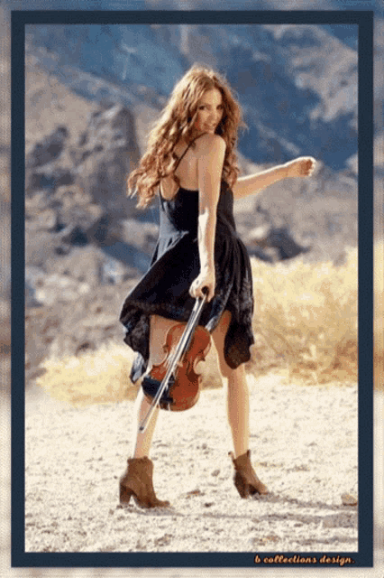 a woman in a black dress holding a violin
