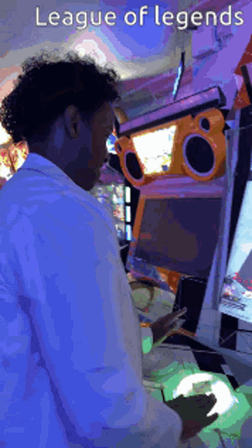 a man playing a video game with the words league of legends on the bottom