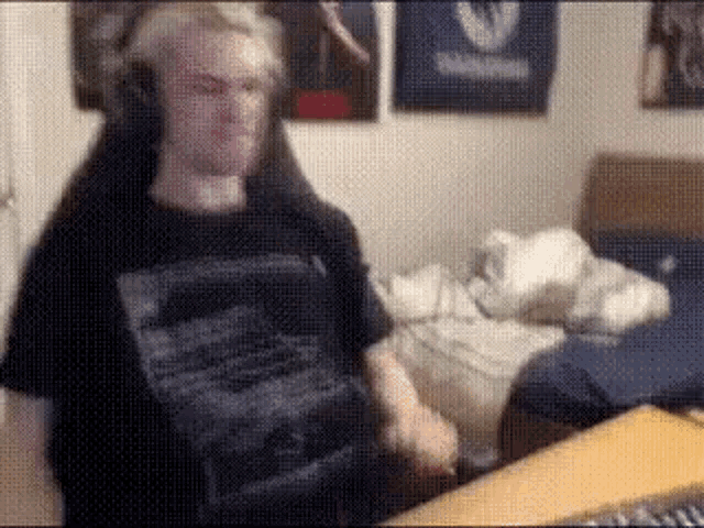 a man wearing headphones is sitting in a chair in front of a computer .