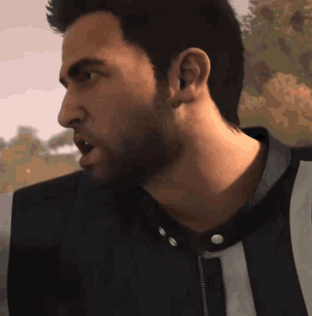 a man with a beard is wearing a black jacket