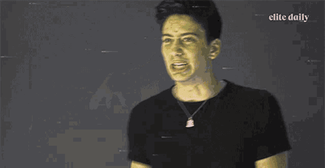 a man in a black shirt with elite daily in the corner