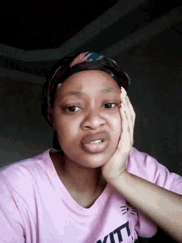 a woman wearing a pink shirt that says ytl on it