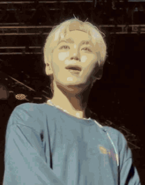 a man with blonde hair is wearing a blue shirt that says ' i love you ' on the front