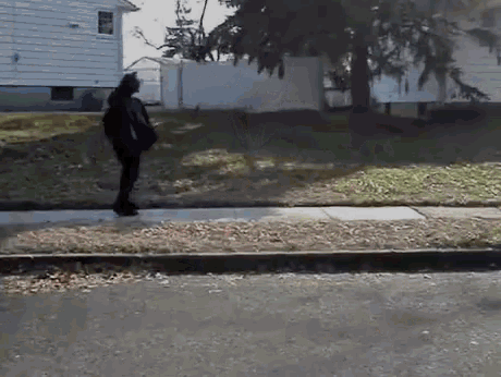 a person walking down a sidewalk with a bag on their back