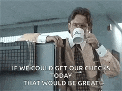 a man in a suit and tie is drinking a cup of coffee from a mug .