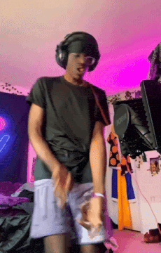a man wearing headphones and shorts is standing in front of a microphone that says rode