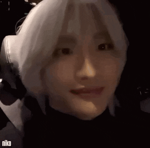 a close up of a person 's face with white hair making a funny face .