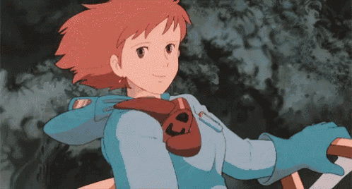 a girl with red hair and blue gloves is holding a piece of paper .