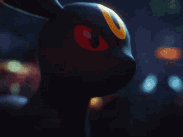 a black rabbit with red eyes and a yellow u on its head