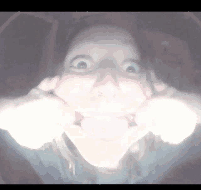 a person making a funny face with their hands on their face