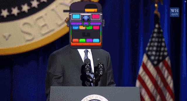 a man in a suit and tie stands at a podium in front of a sign that says ' states ' on it