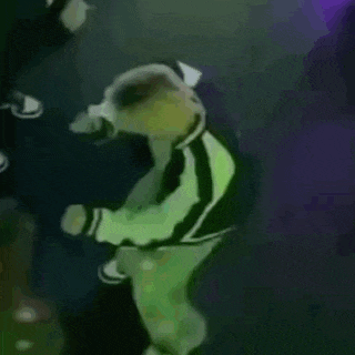 a person in a green jacket is flying through the air .