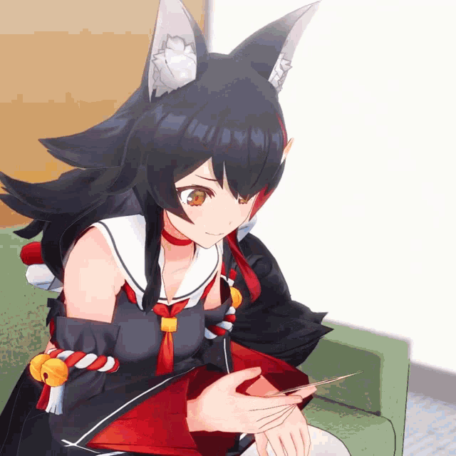 a girl with a cat ear is sitting on a couch holding a piece of paper