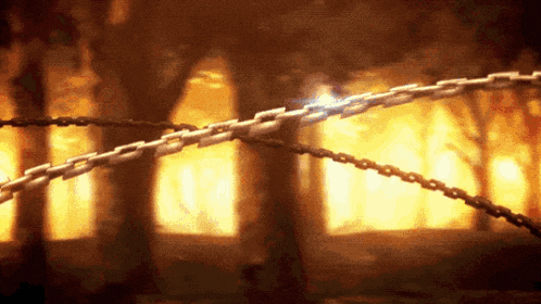 a chain is breaking in the middle of a forest with trees in the background