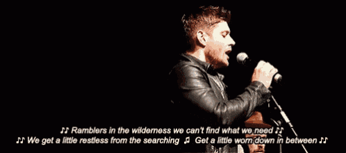 a man singing into a microphone with the words " we get a little restless from the searching " on the bottom