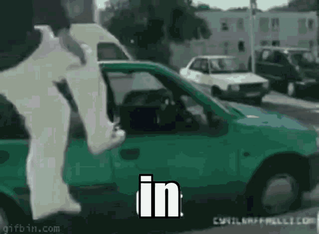a person is jumping out of a car with the word in written on it