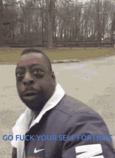 a man in a nike jacket with the words go fuck your self fortnite