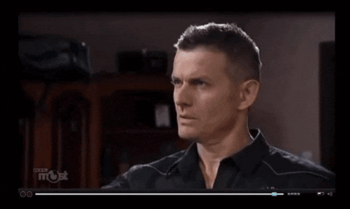 a man in a black shirt is being shown on a tv screen that says fox