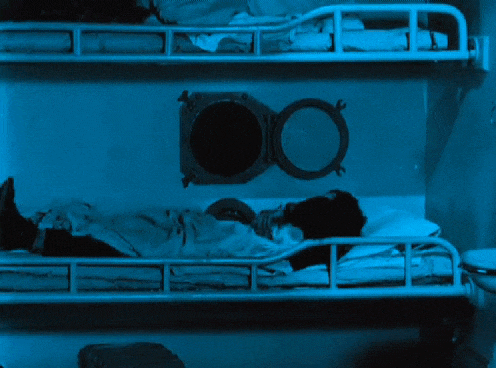a person standing in front of a bunk bed