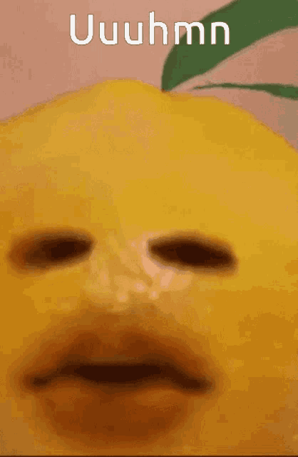 a close up of a lemon with the word uuhmn written on it
