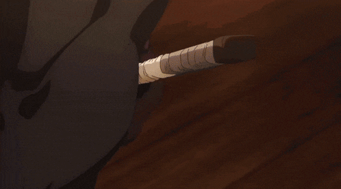 a close up of a person 's hand holding a bottle of something .