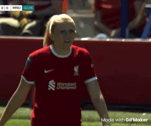 a female soccer player wearing a red jersey with standard chartered on it