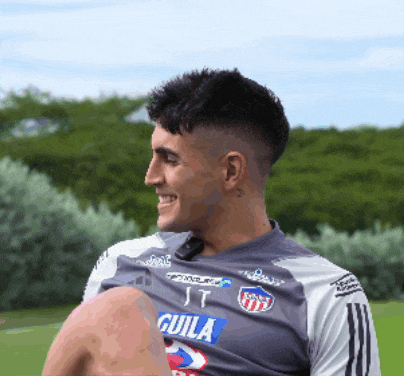 a man wearing a shirt that says " it guila " on it