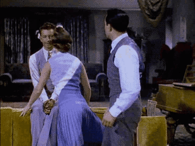 a man and woman are dancing in a living room