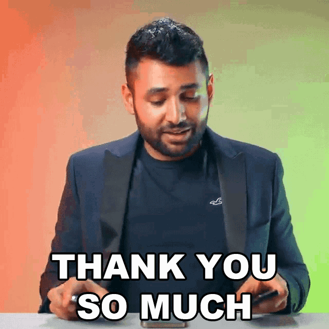 a man in a suit is holding a cell phone and saying thank you so much