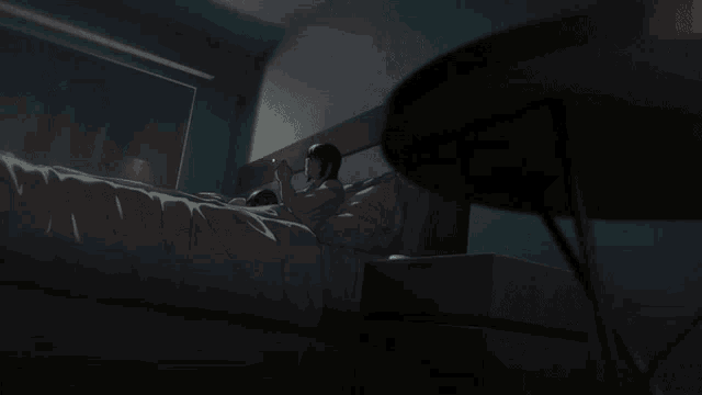 a man is smoking a cigarette next to a woman who is laying down