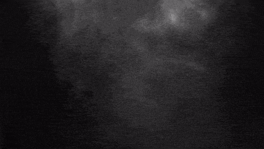 white smoke is coming out of a pipe on a black background