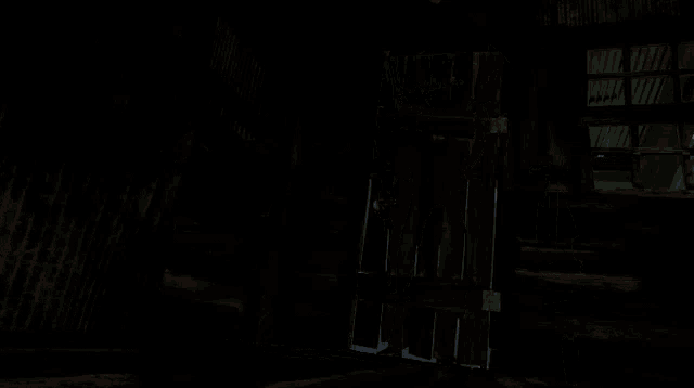 a man is holding a gun in a dark room .