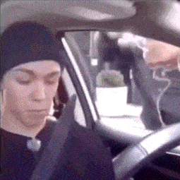 a man wearing a beanie is sitting in a car .