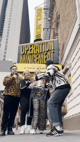 a group of people posing in front of a sign that says operation mincemeat