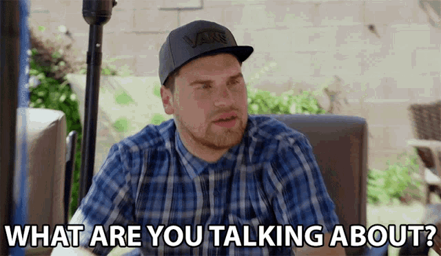 a man wearing a hat that says vans on it