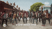 a group of people are dancing on a dirt road and the words vibe with me are on the bottom of the image