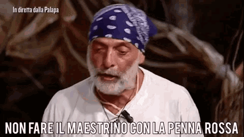 a man with a beard and a bandana on his head says non fare il maestro con la penna rossa .