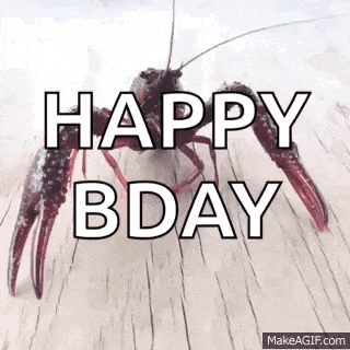 a crayfish is crawling on a wooden surface with the words `` happy bday '' written above it .