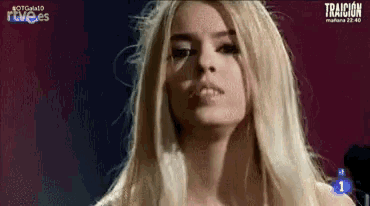 a close up of a woman 's face with the word traicion on the bottom right