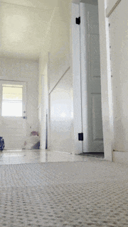 a person is bending over in a hallway