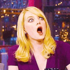 a woman with blonde hair and a surprised look on her face