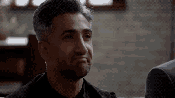 a close up of a man 's face with a sad look on his face