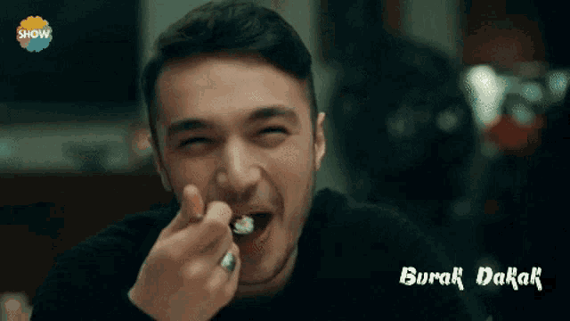 a man with a ring on his finger is making a funny face