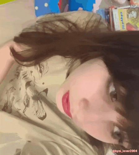 a close up of a woman 's face with the name kyli_lover2004 on the bottom right corner