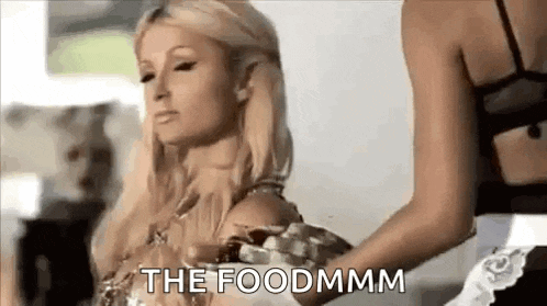 a woman is holding a plate of food in front of a woman .