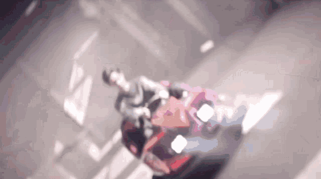 a blurred image of a person riding a red car