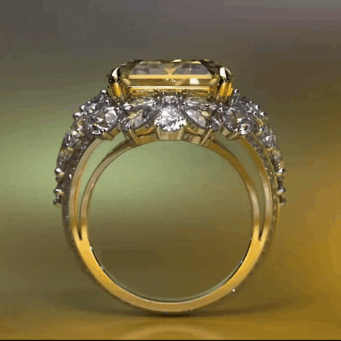 a yellow gold ring with a yellow stone and diamonds